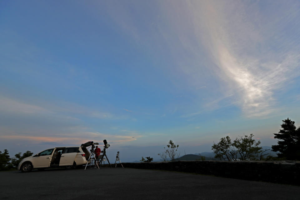 Astrophotographer Johnny Horne sets up his gear beside his vehicle on the slopes of Grandfather Mountain to photograph Comet NEOWISE in Linville, N.C., Friday, July 17, 2020. (AP Photo/Gerry Broome)