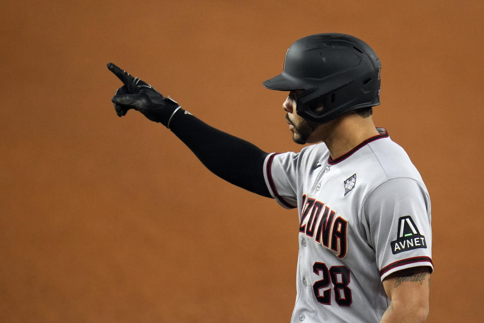 Arizona Diamondbacks' Tommy Pham celebrates after hitting a single against the Texas Rangers during the eighth inning in Game 2 of the baseball World Series Saturday, Oct. 28, 2023, in Arlington, Texas. (AP Photo/Julio Cortez)