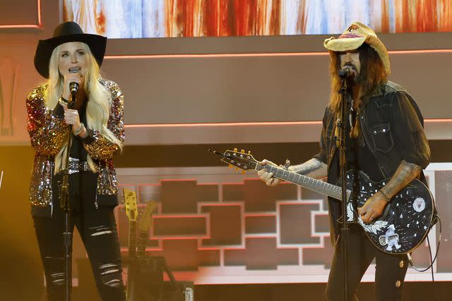 <p>Jason Kempin/Getty Images for ACM</p> Firerose and Billy Ray Cyrus perform in Nashville in August 2023