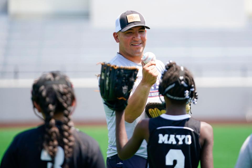 New York Yankees catcher Jose Trevino talks to the Paterson Divas softball team during a skills clinic at Hinchliffe Stadium on Wednesday, July 5, 2023, in Paterson.