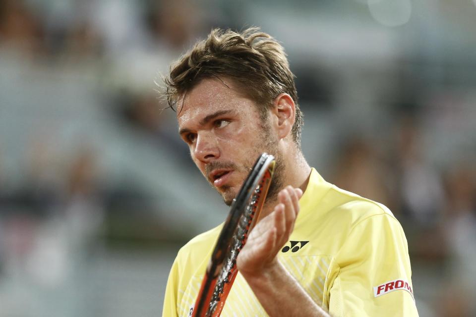 Stanislas Wawrinka from Switzerland claps his racket as Dominic Thiem from Austria wins a point during a Madrid Open tennis tournament match, in Madrid, Spain, Tuesday, May 6, 2014. (AP Photo/Andres Kudacki)
