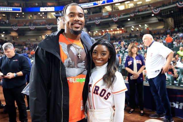 <p>Carmen Mandato/Getty</p> Simone Biles and Jonathan Owens pose on the field prior to Game One of the 2022 World Series