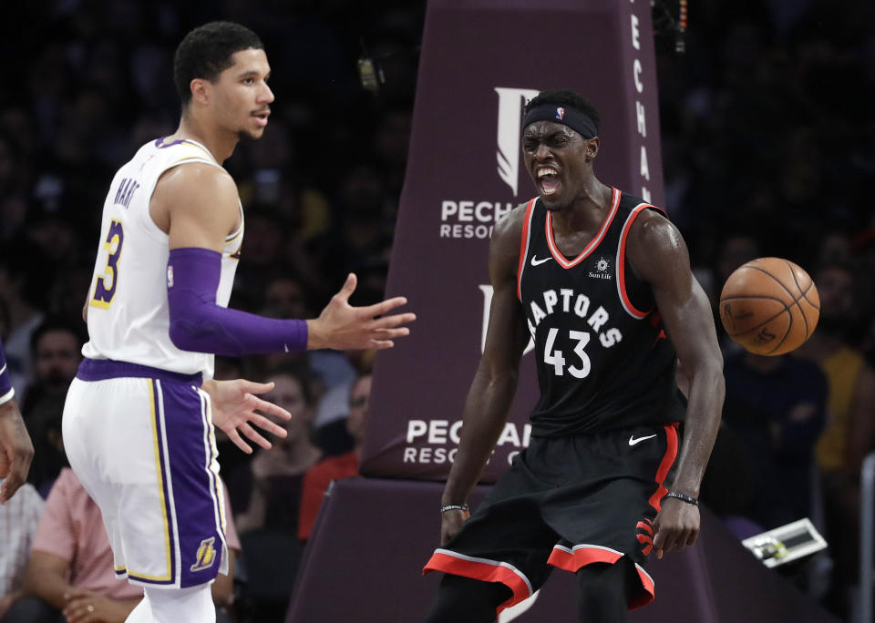 Toronto Raptors' Pascal Siakam, right, celebrates after dunking next to Los Angeles Lakers' Josh Hart (3) during the first half of an NBA basketball game Sunday, Nov. 4, 2018, in Los Angeles. (AP Photo/Marcio Jose Sanchez)