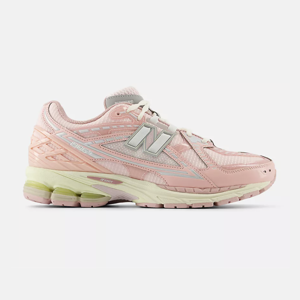 A light pink New Balance sneaker with light green, baby blue, and gray accents