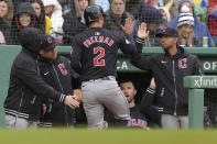 Cleveland Guardians' Tyler Freeman (2) is welcomed to the dugout after scoring on a single by Ramón Laureano in the sixth inning of a baseball game against the Boston Red Sox, Thursday, April 18, 2024, in Boston. (AP Photo/Steven Senne)