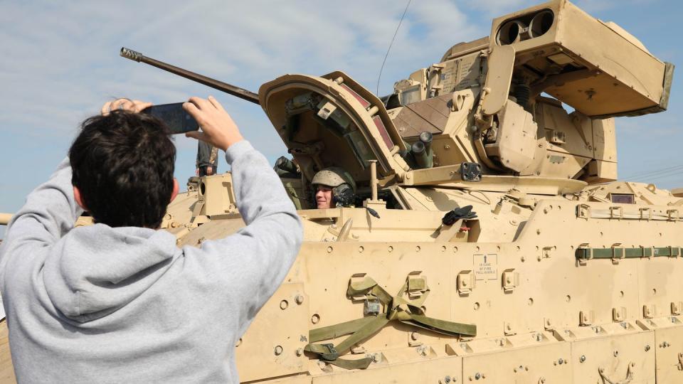 A Junior Reserve Officers Training Corps student from Shoemaker High School, takes a photo of the M2 Bradley Infantry Fighting Vehicle during a Career Fair hosted by the 1st Cavalry Division, on Fort Cavazos, Texas, March 29, 2023. (Pfc. David Dumas/Army)