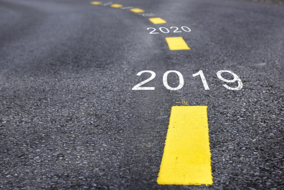 A road with the years 2019 and 2020 written between the yellow stripes.