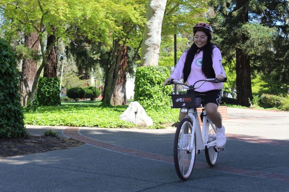 University of the Pacific student Cynthia E. Fuentes takes an electric bike for a spin at the Rise 'N' Ride event on Saturday, April 1, 2023.