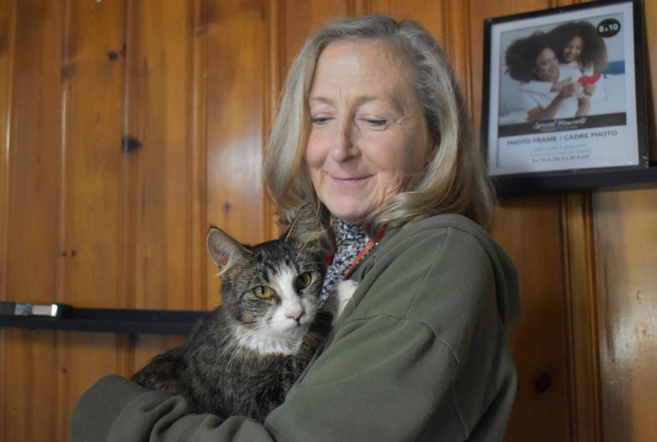 Mary Kotuba, founder of Semper Fi Felines & Mary's Misfits, holds now-adoptable Oreo.