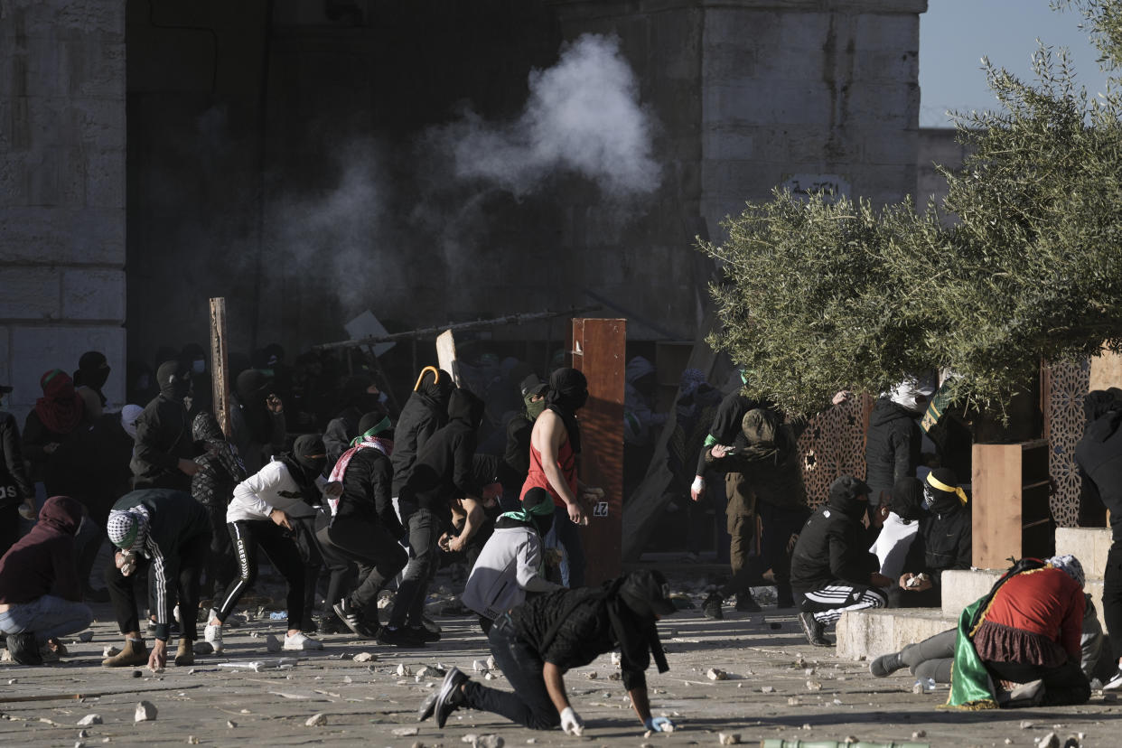 Palestinians clash with Israeli security forces at the Al Aqsa Mosque compound in Jerusalem's Old City Friday, April 15, 2022. (AP Photo/Mahmoud Illean)