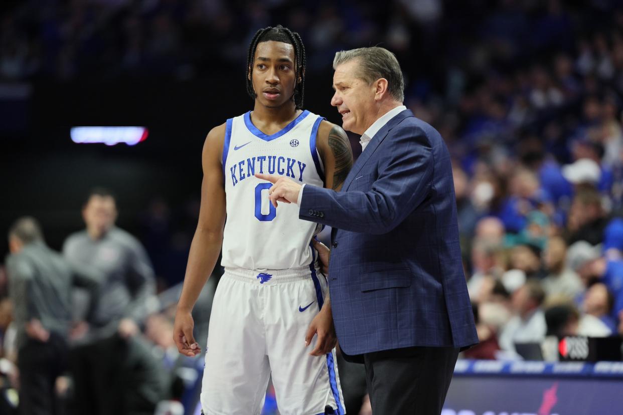 Coach Cal with guard Rob Dillingham during Wednesday's victory. (Andy Lyons/Getty Images)