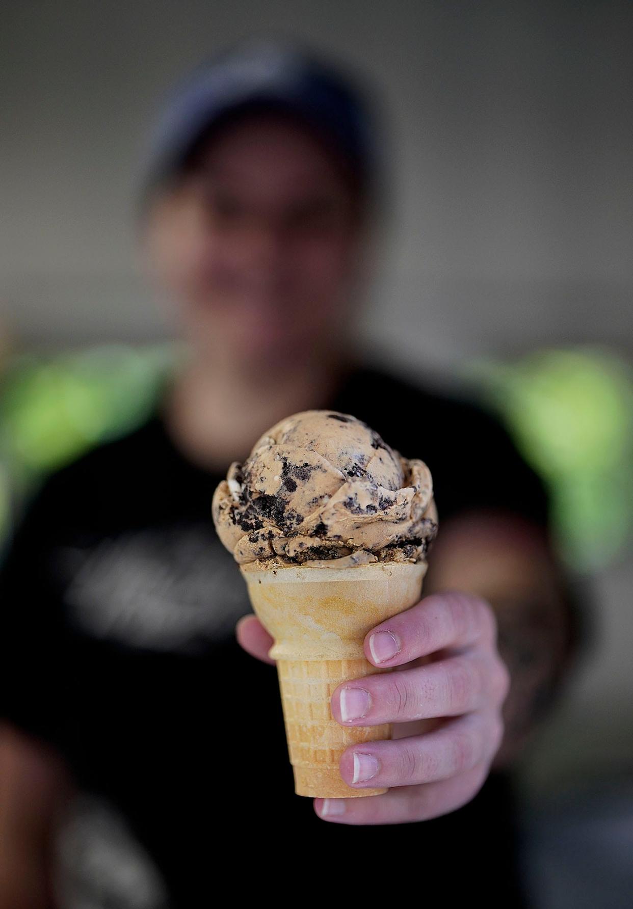 Emilee Flynn, an assistant manager at Wright's Creamery in North Smithfield, holds a cone with coffee Oreo ice cream, which ranks as Rhode Islanders' third-favorite flavor, according to an informal survey of ice cream shops.