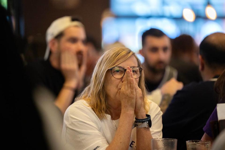 Sacramento Kings fan Kellie Haynes shields her face during the first half as fans gathered to watch the play-in game between the Sacramento Kings and the New Orleans Pelicans at Sauced in downtown Sacramento on Friday.