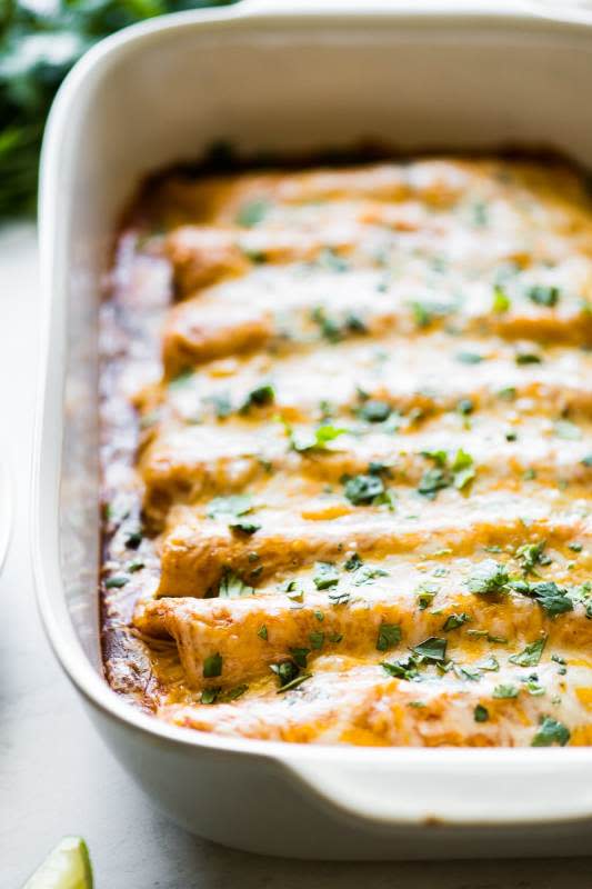 <p>Isabel Eats</p><p>These easy chicken enchiladas are stuffed with shredded chicken and cheese, topped with an easy red enchilada sauce and baked for 20 minutes.</p><p><strong>Get the recipe: <a href="https://www.isabeleats.com/red-chicken-enchiladas/" rel="nofollow noopener" target="_blank" data-ylk="slk:Easy Chicken Enchiladas;elm:context_link;itc:0;sec:content-canvas" class="link rapid-noclick-resp">Easy Chicken Enchiladas</a></strong></p>