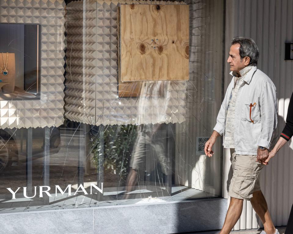 A man walks past the David Yurman jewelry store on Tuesday.