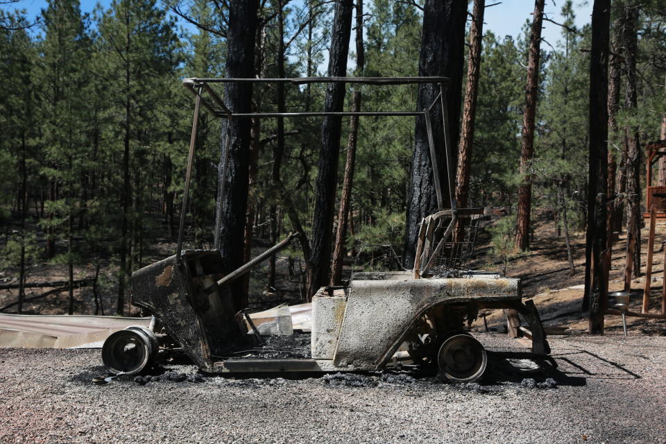 A burned golf cart is seen in an RV park following a wildfire near Las Vegas, New Mexico, on Monday, May 2, 2022. Wind-whipped flames are marching across more of New Mexico's tinder-dry mountainsides, forcing the evacuation of area residents and dozens of patients from the state's psychiatric hospital as firefighters scramble to keep new wildfires from growing. The big blaze burning near the community of Las Vegas has charred more than 217 square miles. (AP Photo/Cedar Attanasio)