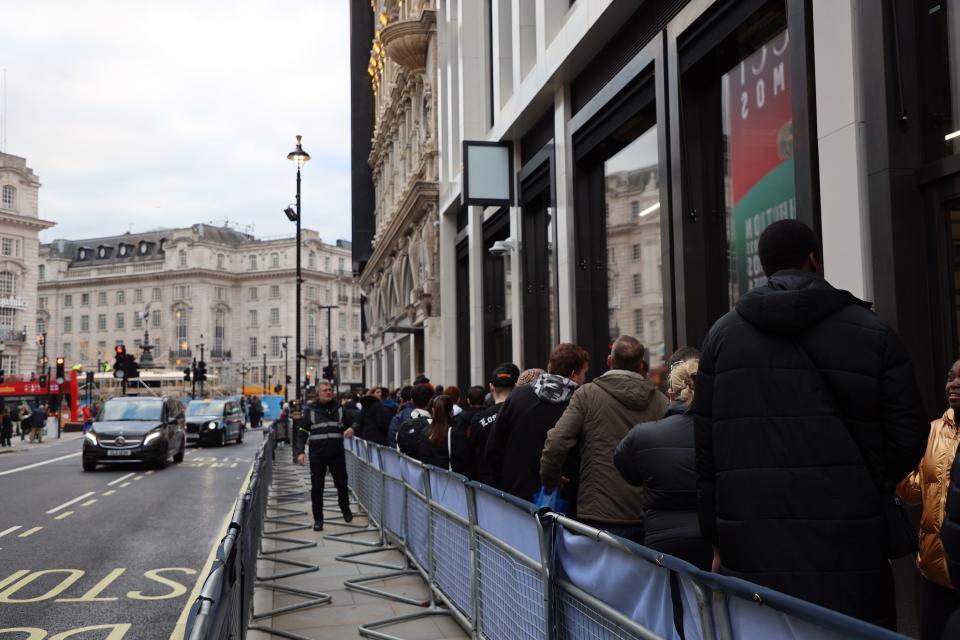 People lining up near Piccadilly Circus, London.