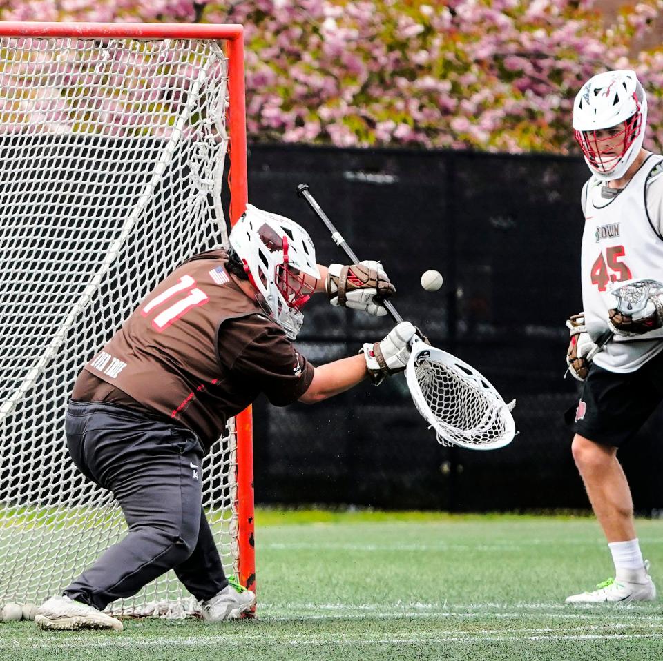 Brown  goalie Connor Theriault stops a shot during practice on Wednesday.