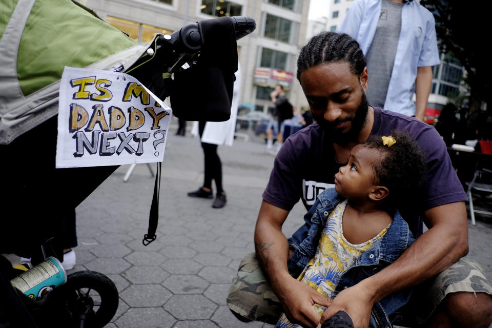 People take part in a protest against the killing of Alton Sterling, Philando Castile and in support of Black Lives Matter during a march along Manhattan's streets in New York on July 8, 2016.