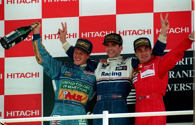 Britain’s Damon Hill, centre, poses on the podium alongside championship leader Michael Schumacher, left, and race runner-up Jean Alesi, right, in 1994. Hill followed in the footsteps of father, Graham, by driving to victory at Silverstone, doing so in his Williams Renault