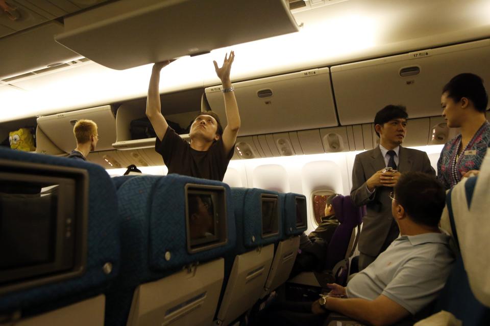 Passengers take their seats in a Malaysia Airlines Boeing 777-200ER flight MH318 to Beijing before take off at Kuala Lumpur International Airport