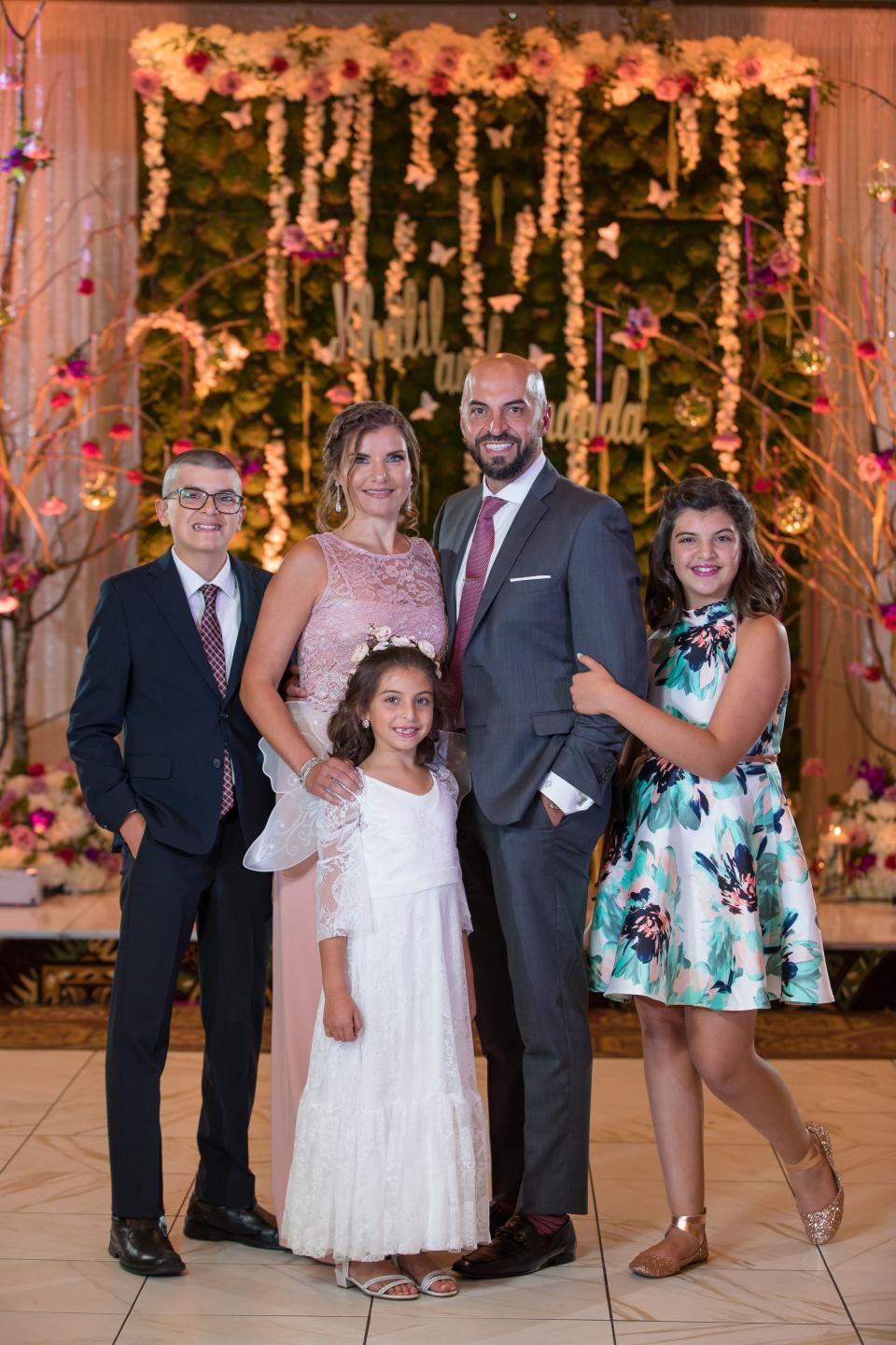 The Abbas family, clockwise from left, Ali, Rima, Issam, Isabelle and Giselle, pose for a photo at a wedding in 2018.