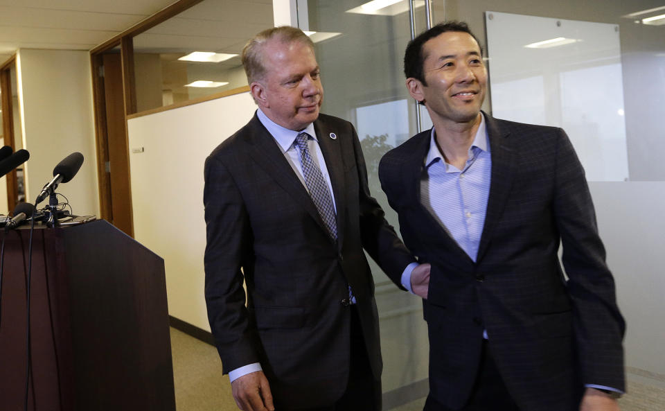 Seattle Mayor Ed Murray, left, walks away with his husband, Michael Shiosaki, after reading a statement to media members, Friday, April 7, 2017, in Seattle. A lawsuit filed Thursday accuses Murray of sexually molesting a teenage high-school dropout in the 1980s, and in interviews with The Seattle Times, two other men claim he abused them. The mayor denied the allegations through his personal spokesman Jeff Reading. (AP Photo/Elaine Thompson)