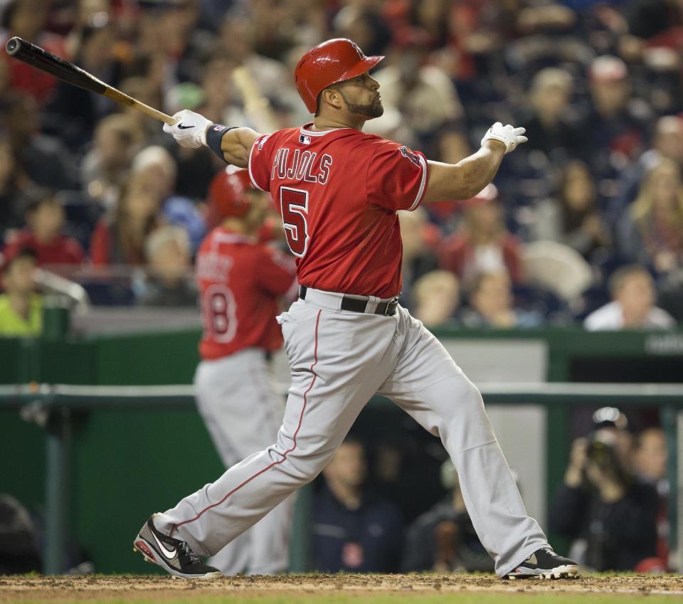 Los Angeles Angels Albert Pujols watches the ball after connecting for a two-run homer against Washington Nationals Taylor Jordan in the fifth inning of a baseball game in Washington, Tuesday, April 22, 2014. This was Pujols 500th career home run. (AP Photo/Pablo Martinez Monsivais)