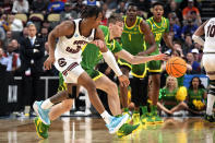 South Carolina's Meechie Johnson, left, and Oregon guard Brennan Rigsby scramble for a loose ball during the first half of a first-round college basketball game in the NCAA Tournament in Pittsburgh, Thursday, March 21, 2024. (AP Photo/Gene J. Puskar)