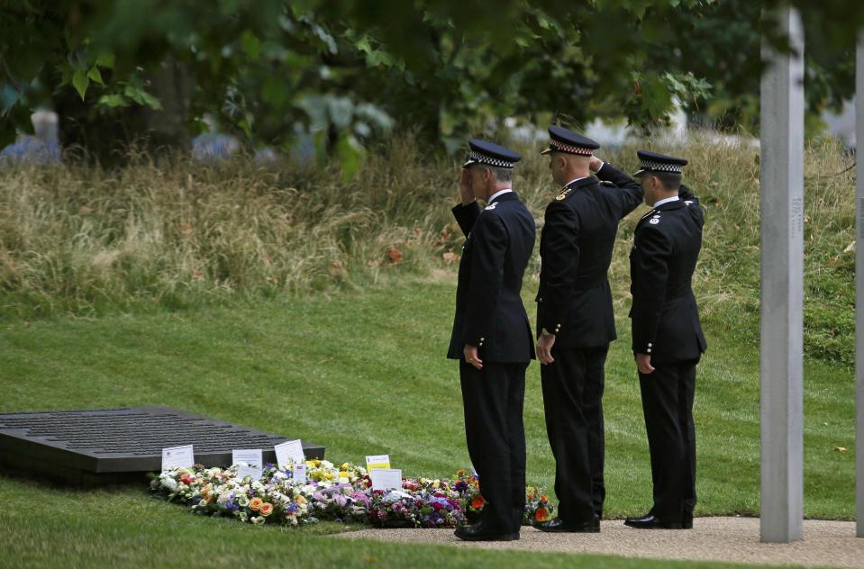 Police officers salute as they lay wreaths at the memorial to victims of the July 7, 2005 London bombings, in Hyde Park, central London, Britain July 7, 2015. Britain fell silent on Tuesday to commemorate the 10th anniversary of attacks targeting London public transport which killed 56 people, the first suicide bombings by Islamist militants in western Europe. (REUTERS/Peter Nicholls)