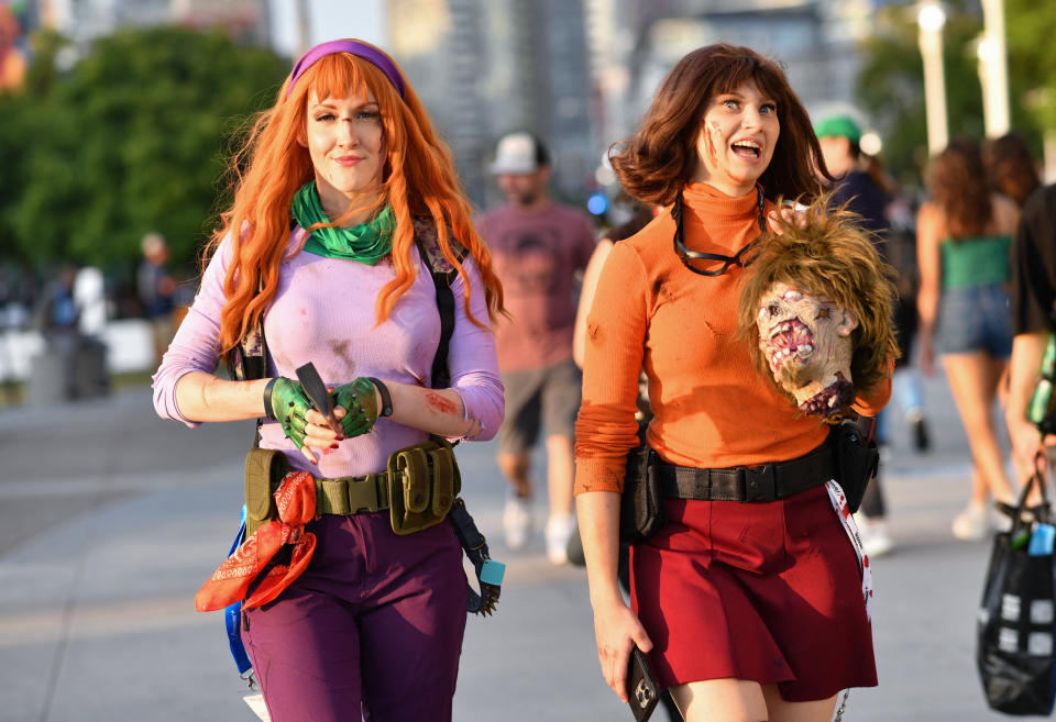 Cosplayers dressed as zombie hunting Daphne and Velma from Scooby Doo.