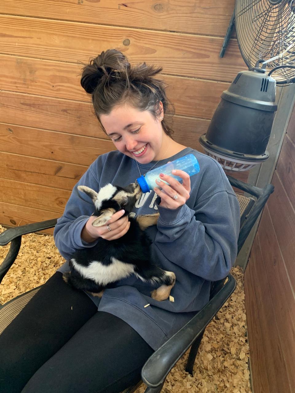 Quincy reporter Mary Whitfill bottle feeds a baby goat named Liesl on her family's farm in Texas.