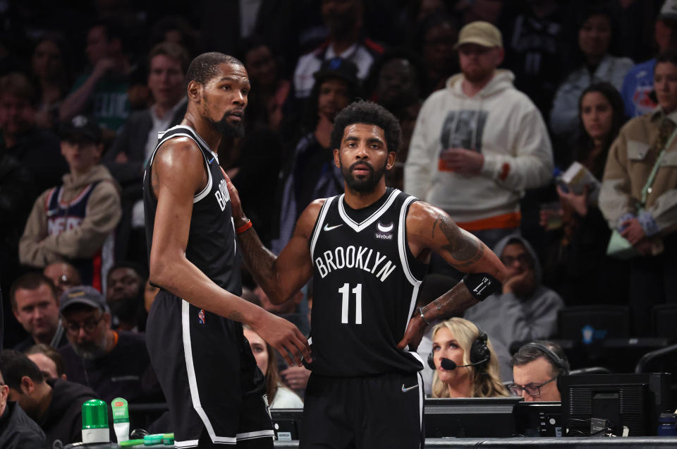 NEW YORK, NEW YORK - APRIL 23:  Kevin Durant #7 and Kyrie Irving #11 of the Brooklyn Nets look on in the final seconds of their 109-103 loss against the Boston Celtics during Game Three of the Eastern Conference First Round NBA Playoffs at Barclays Center on April 23, 2022 in New York City.  NOTE TO USER: User expressly acknowledges and agrees that, by downloading and or using this photograph, User is consenting to the terms and conditions of the Getty Images License Agreement.  (Photo by Al Bello/Getty Images).