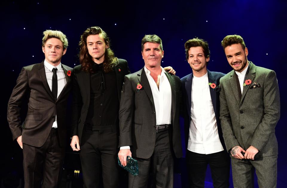 Simon Cowell with One Direction, a group he helped found, in 2015 (Ian West/PA Archive/PA Images)