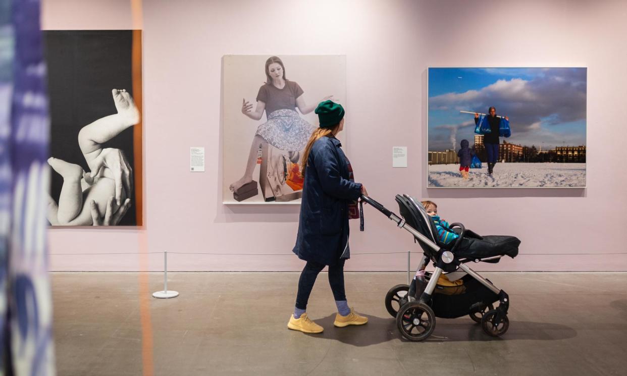 <span>‘Vital inspiration’: a visitor walks past Valie Export’s Die Geburtenmadonna, 1976 (centre) and Untitled, February 2013 by Hannah Starkey at Arnolfini, Bristol.</span><span>Photograph: Courtesy Arnolfini and Hayward Gallery Touring</span>