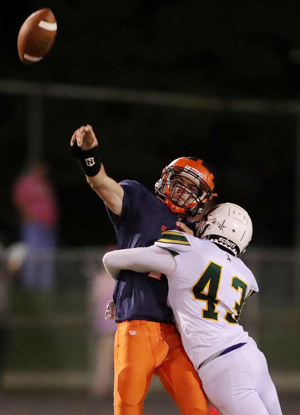 Ellet quarterback Alex Faulconer, facing, gets a pass off before being brought down by Firestone linebacker Carlo Johnson during the second half of a football game, Thursday, Oct. 7, 2021, in Akron, Ohio.