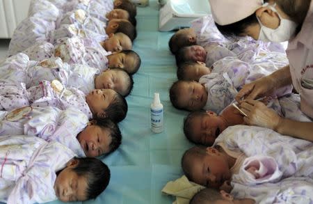 FILE PHOTO: Newly born babies receive vaccines at a hospital in Aksu, Xinjiang Uighur Autonomous Region August 10, 2012. REUTERS/Stringer