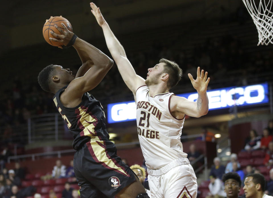 Florida State's Mfiondu Kabengele, left, tries to drive past Boston College's Nik Popovic, right, in the first half of an NCAA college basketball game, Sunday, Jan. 20, 2019, in Boston. (AP Photo/Steven Senne)