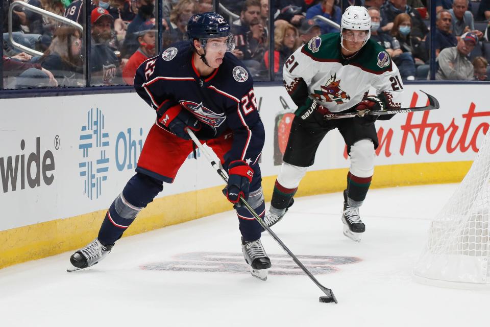 Columbus Blue Jackets defenseman Jake Bean (22) skates around Arizona Coyotes left wing Loui Eriksson (21) during the second period of the season opening NHL hockey game at Nationwide Arena in Columbus on Thursday, Oct. 14, 2021. 