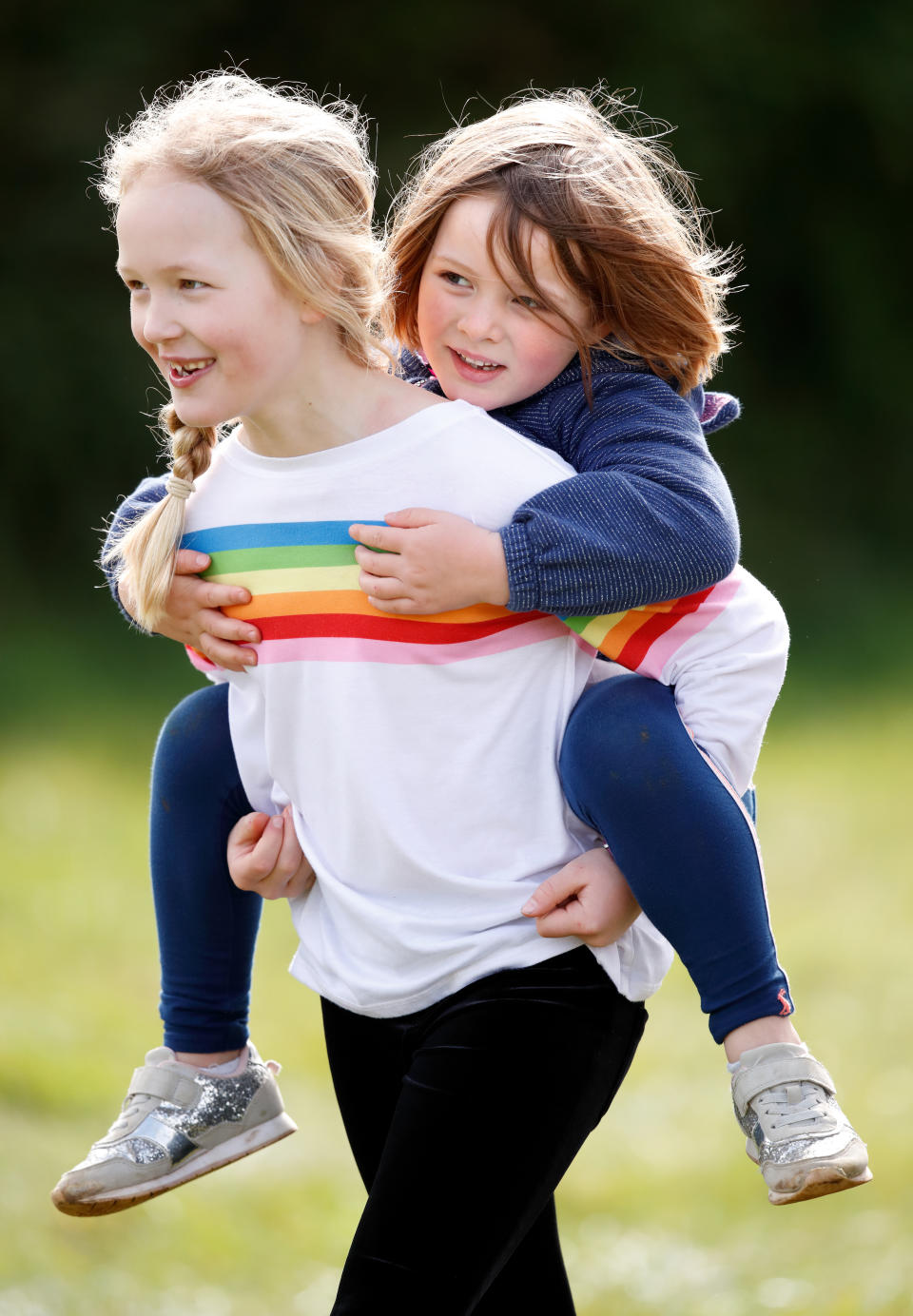 STROUD, UNITED KINGDOM - MARCH 23: (EMBARGOED FOR PUBLICATION IN UK NEWSPAPERS UNTIL 24 HOURS AFTER CREATE DATE AND TIME) Savanah Phillips gives her cousin Mia Tindall a piggyback as they attend the Gatcombe Horse Trials at Gatcombe Park on March 23, 2019 in Stroud, England. (Photo by Max Mumby/Indigo/Getty Images)