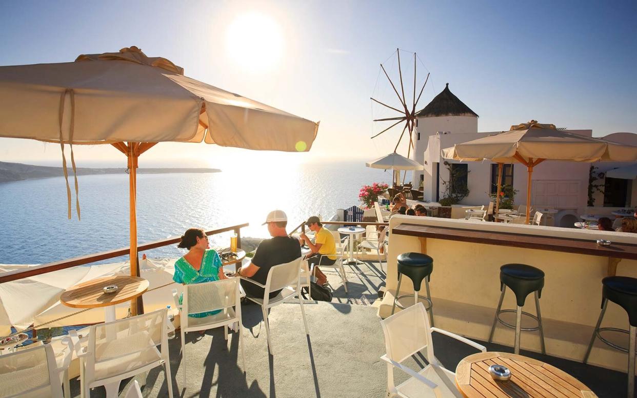 Greece, Cyclades, Santorini, Oia Town, outdoor cafe hotel Off Peak Holiday Vacation Hotel Booking Travel