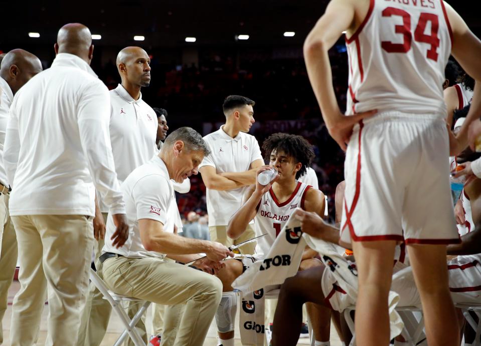 OU men's basketball coach Porter Mosier talks to his team during a timeout Saturday at Lloyd Noble Center.