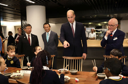 Britain's Prince William joins local school children from St Cuthbert with St Matthias CE Primary School at a copper beating workshop during the official opening of Japan House in London, Britain, September 13, 2018. Tim P. Whitby/Pool via REUTERS