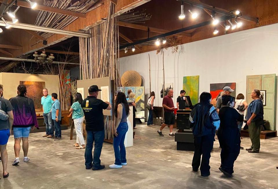 ArtHop attendees visit one of the several art galleries and artist studios clustered along Mono Street in downtown Fresno on October, 5, 2023.