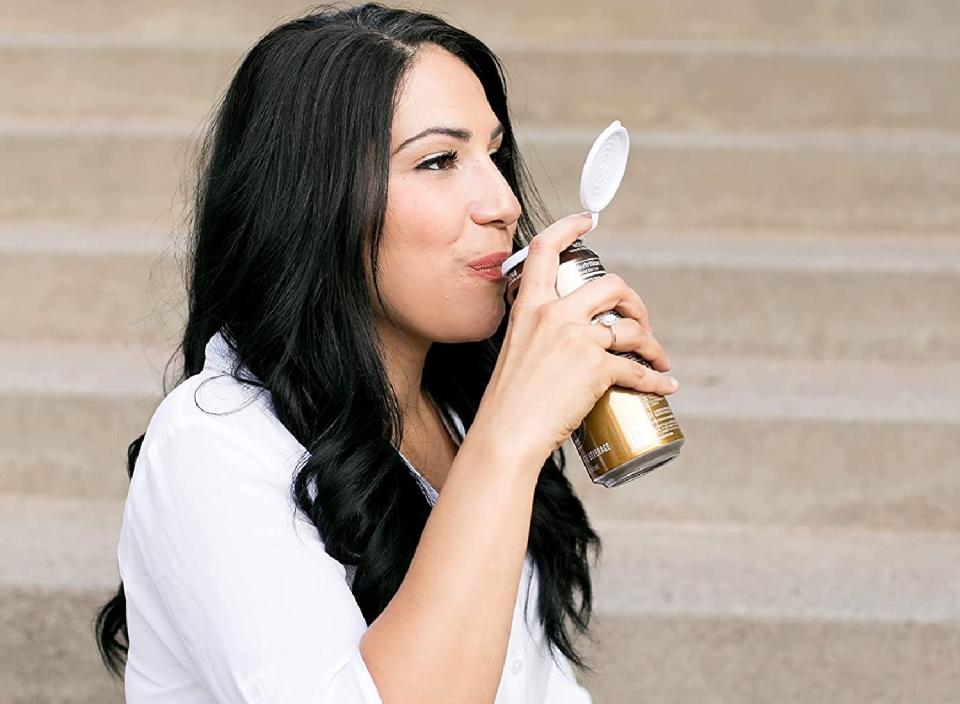 Model drinking from a can with a plastic lid.
