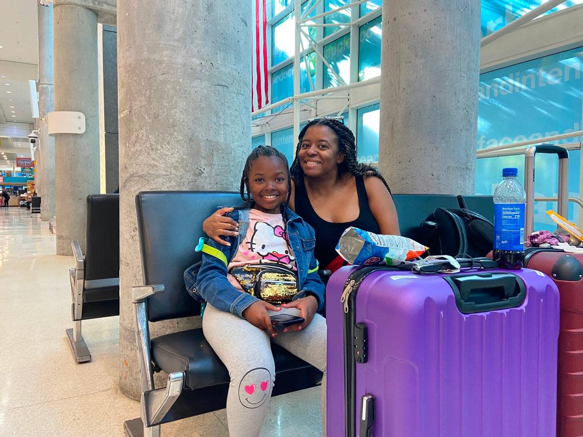 Adrienne Johnson, 10, and her mother, Allison Douglas, wait in the Fort Lauderdale International Airport terminal for an afternoon flight to Philadelphia Friday, April 14, 2023. 