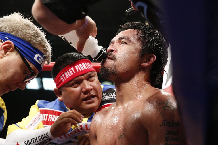 Manny Pacquiao with trainer Freddie Roach between rounds in his welterweight unification championship bout with Floyd Mayweather on May 2, 2015 at MGM Grand Garden Arena