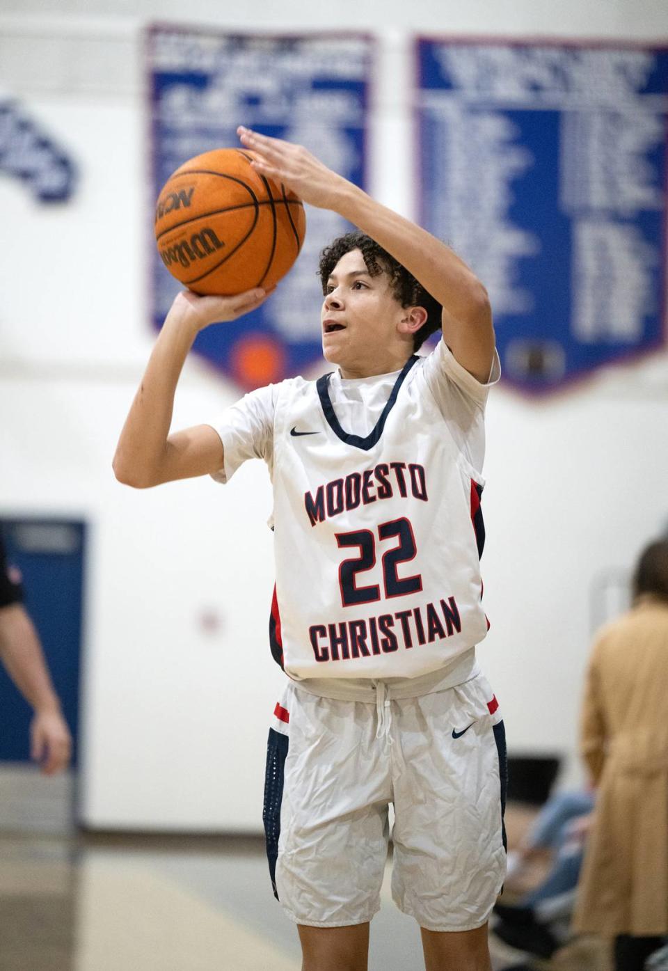 Modesto Christian’s Trevor Dickson attempts a three-point shot during the Sac-Joaquin Section playoff game with Cosumnes Oaks at Modesto Christian High School in Salida, Calif., Wednesday, Feb. 14, 2024.