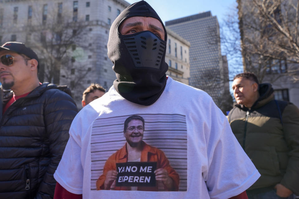 A demonstrator wears a t-shit with a mockup mugshot of Former Honduran President Juan Orlando Hernandez outside Federal court, Friday, March 8, 2024, in New York. Former Honduran President Juan Orlando Hernandez has been convicted in New York of conspiring with drug traffickers, his military and police to enable tons of cocaine to reach the United States. (AP Photo/Mary Altaffer)