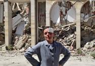 <p>A wounded woman stands in front of a collapsed building following an earthquake in Amatrice, central Italy, Aug. 24, 2016. (REUTERS/Emiliano Grillotti) </p>